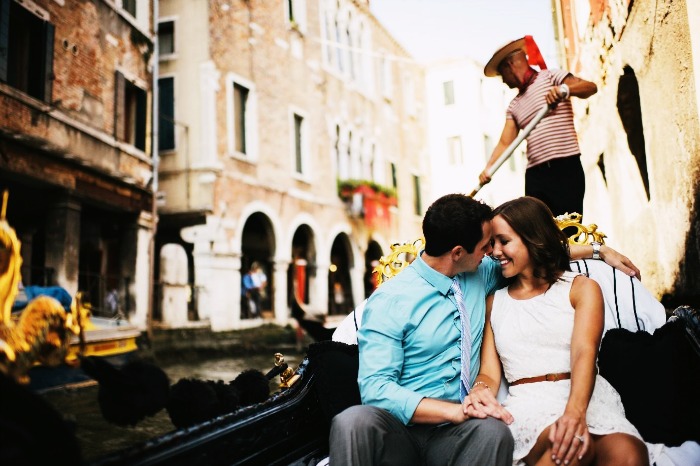 A couple taking a romantic gondola ride in Venice