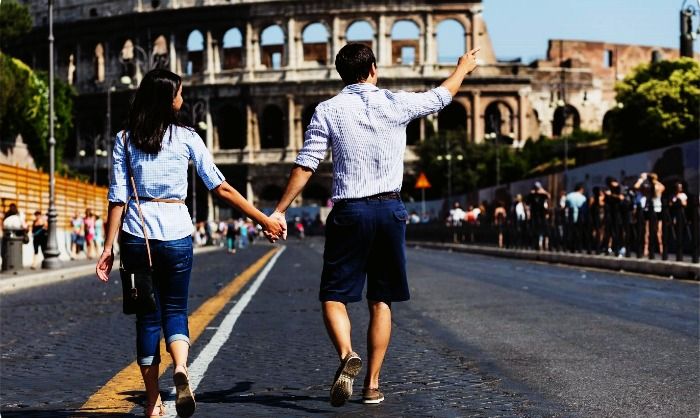 A couple sightseeing in Rome on their honeymoon