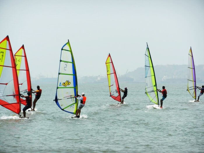 Adventurous surfers windsurfing in Goa
