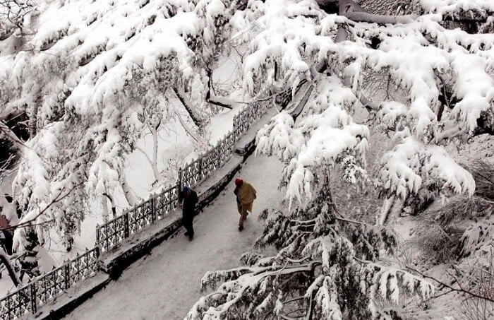 Locals walking in snow covered roads in Dalhousie