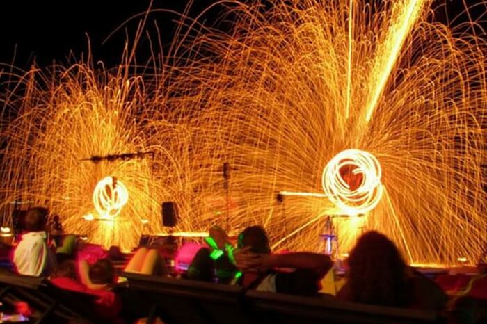 Tourists and locals enjoying a fire performance at the Lamai beach
