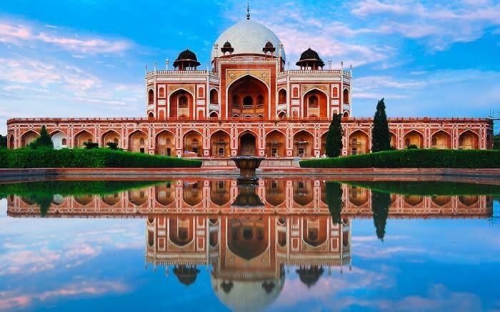 Humayun’s Tomb on a cloudy evening with a mirror image in the front lake