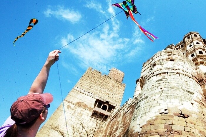 A tourist flies a kite during the International Kite Festival in Jodhpur