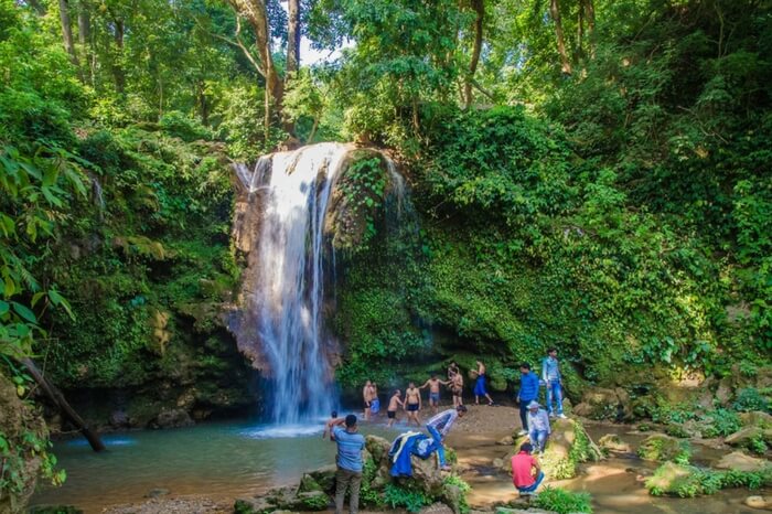 People showering near Corbett Falls in Jim Corbett