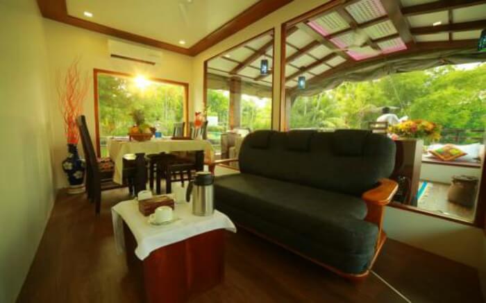Dining space overlooking front deck of Nova Holidays Houseboat in Alleppey