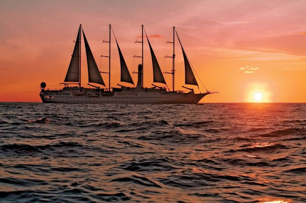 acruise sailing on water during sunset