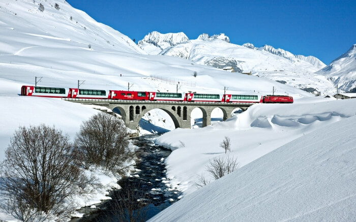 TheGlacier Express crossing a bridge in the Swiss Alps