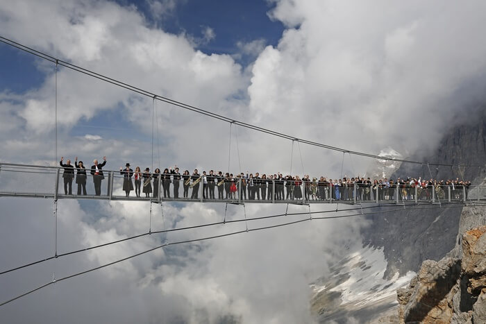People standing at Austria’s Dachstein Stairway - one of the world’s most dangerous walkways