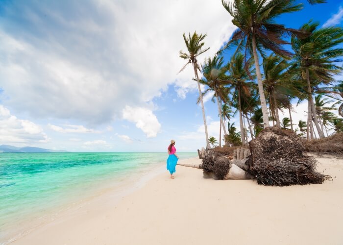 Woman strolling at a beach in Fiji