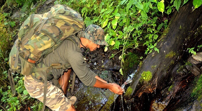 Drinking water from a stream of water on the way to Kheer Ganga