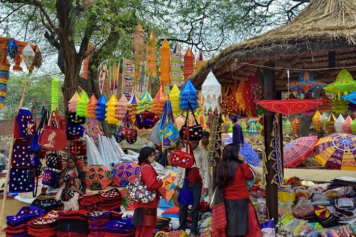 Tourists buying colorful products at the Surajkund Mela in Faridabad