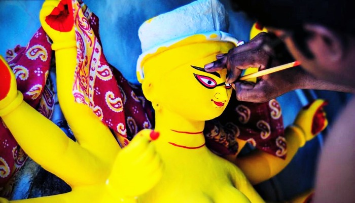 An artist painting the idol of goddess Durga in Kolkata