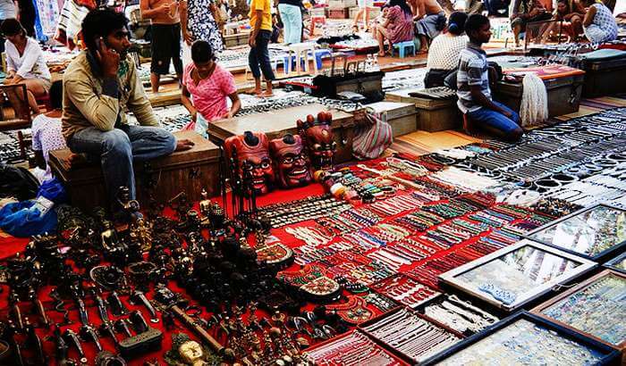 A shopkeeper selling junk jewellery and artefacts at Mapusa Market in Goa