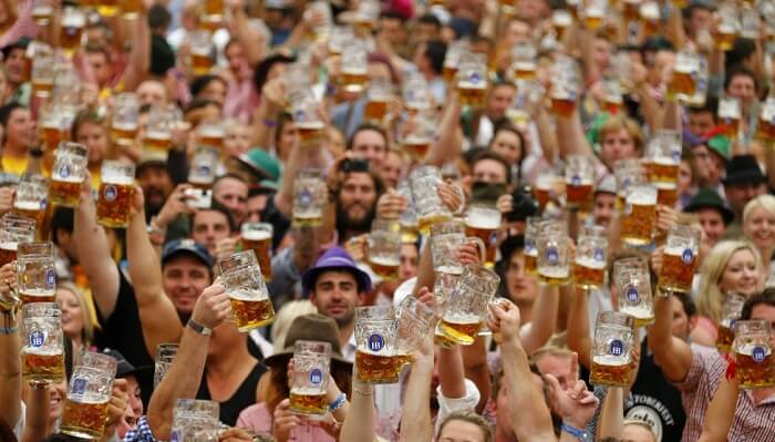 People posing with beer mugs