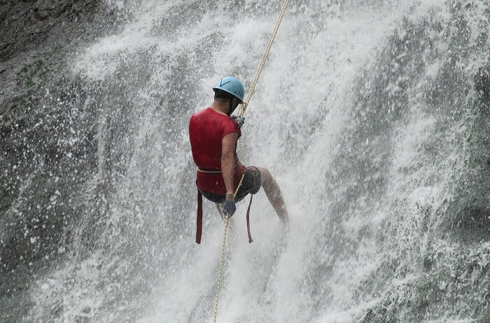 A tourist tries rappelling at waterfalls at Igatpuri