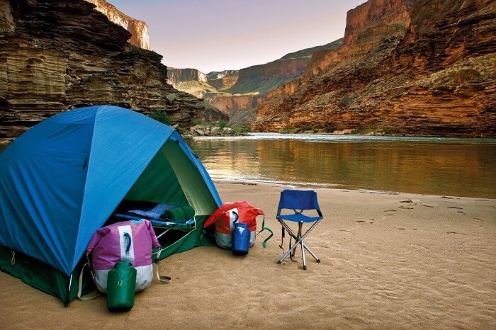 A serene camp between hills and beside quiet waters