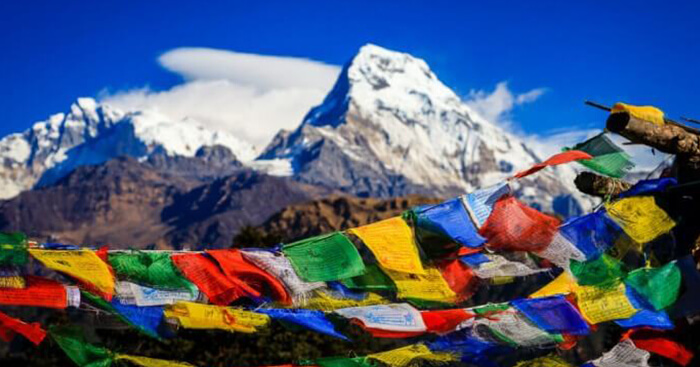 A view of the the prayer flags of Nepal and Himalayas beyond