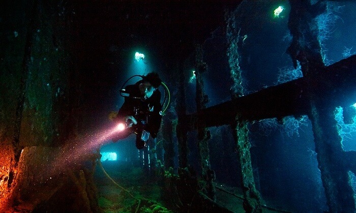 A young explorer at one of the largest ship graveyards of Truk Lagoon