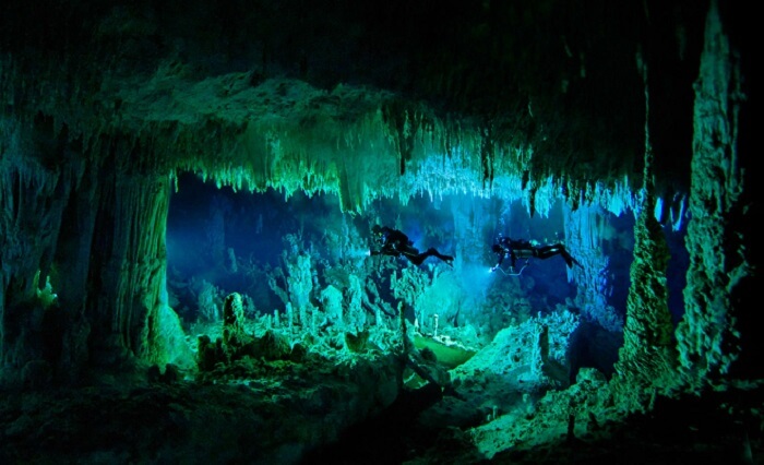 Two persons engaging in cave diving