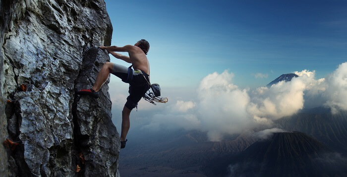 A man climbing a rocky mountain