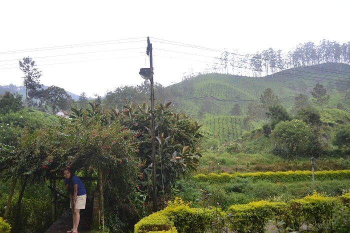 Neha posing in a garden in Munnar