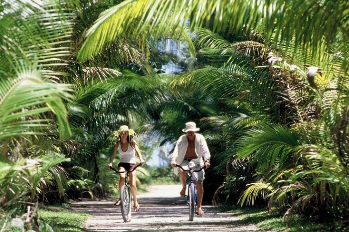 A couple enjoys bicycle ride in Bora Bora