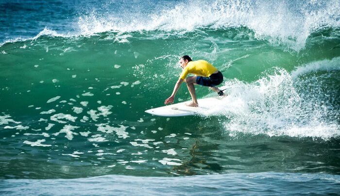 A surfer taking on the waves at Talalla in Sri Lanka