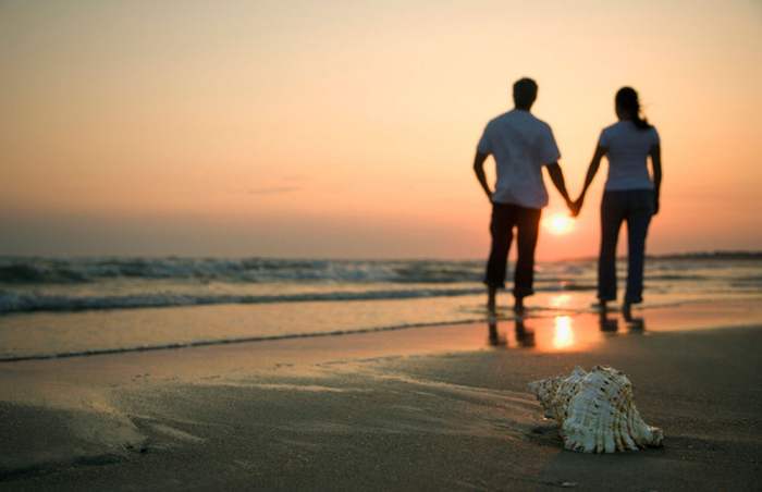 A couple gazing off at Varkala which is a popular honeymoon destination in South India