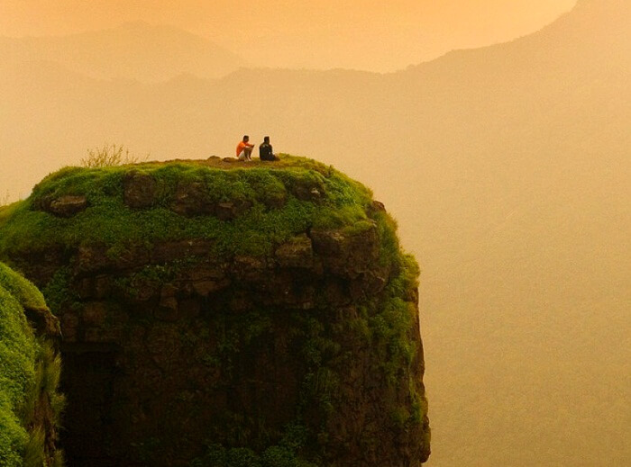 Two friends enjoy the beautiful sunset at the Porcupine Point at Matheran