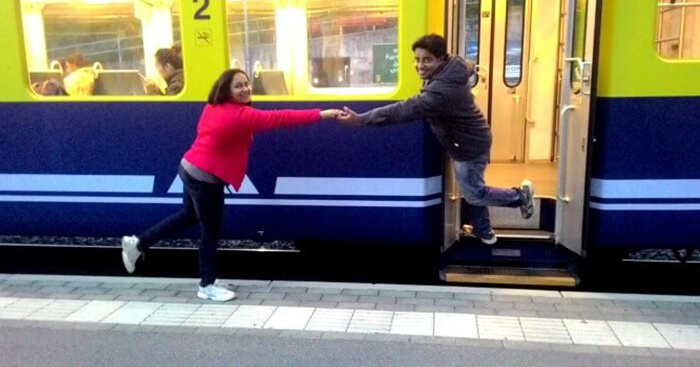 Payal posing in front of a train on her Europe trip