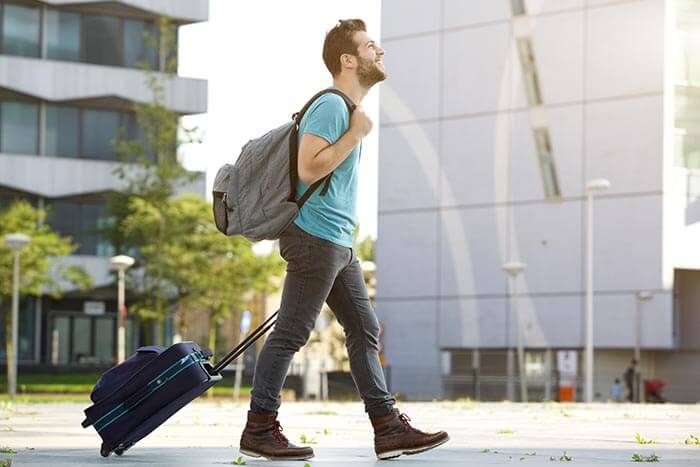 Ecuador: Guy walking with a suitcase