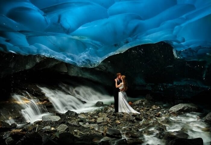 A couple enjoys a kiss at the Mendenhall Ice Cave