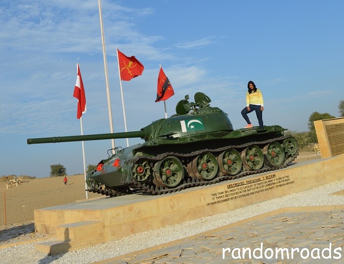 Anusha standing on a Pakistani tank in Longewala