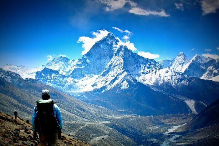 A trekker looks at the majestic Himalayan peaks covered with snow
