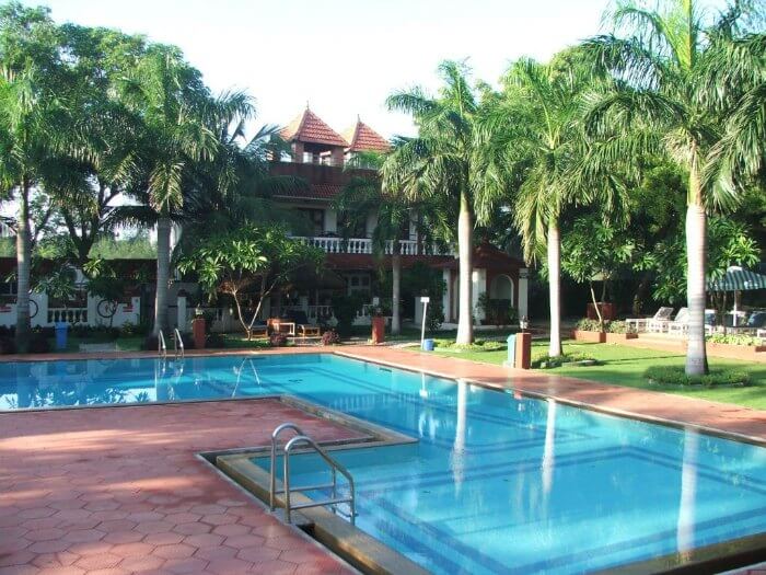 the pool and cottages beyond at InDeco resort