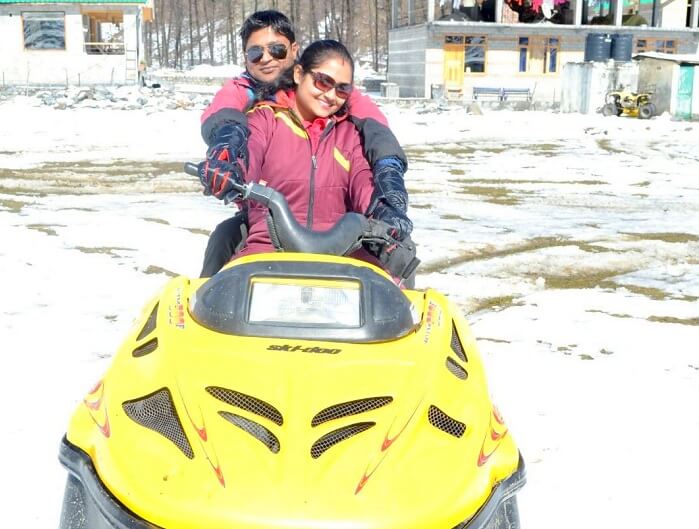 Madhumita and her husband drive the snowmobile