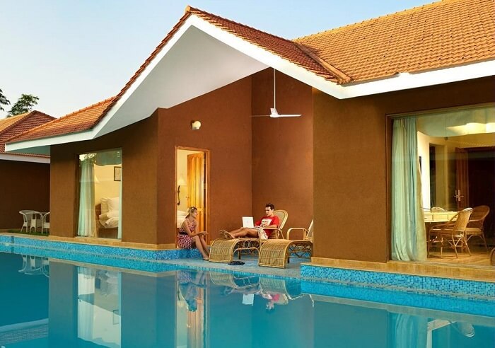 A couple relaxing at SAJ Earth Resort which is among the best resorts in Cochin