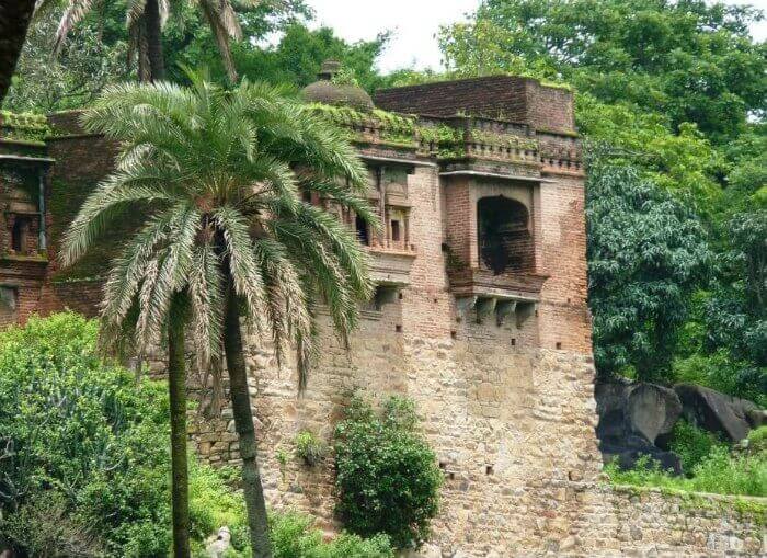 The ruined reminiscent of Achalgarh Fort amidst lush greenery in Mount Abu