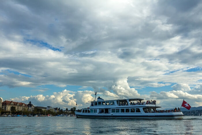 A ferry carrying tourists in the Lake Zurich on a cloudy day