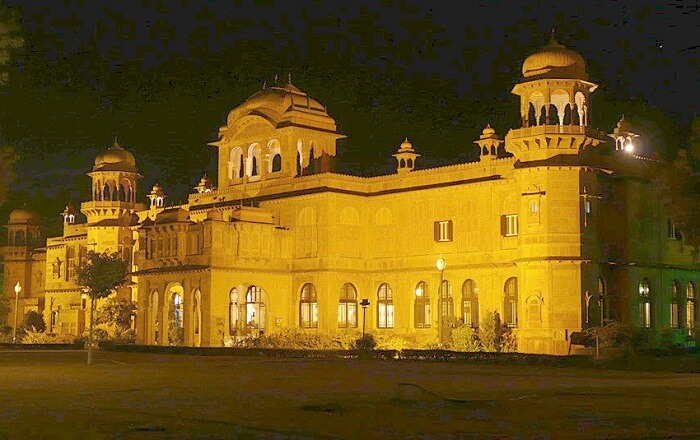 A well-lit entrance of the Lalgarh Palace at night