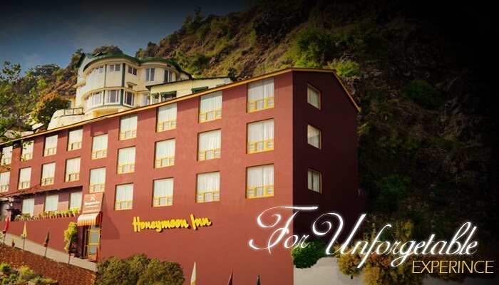 The red building off the Honeymoon Inn with the hills in the background