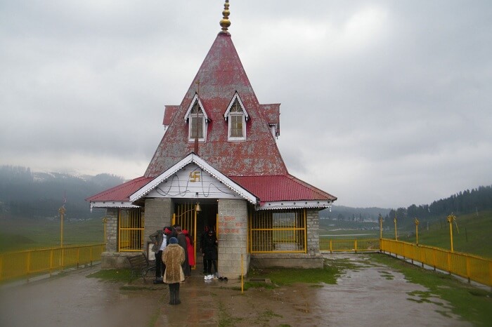 Tourists take blessings at the Maharani Temple in Gulmarg