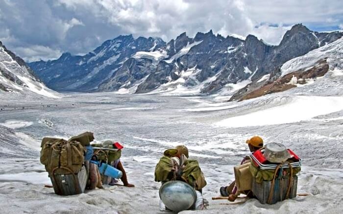 People sitting by the mountain side in Spiti