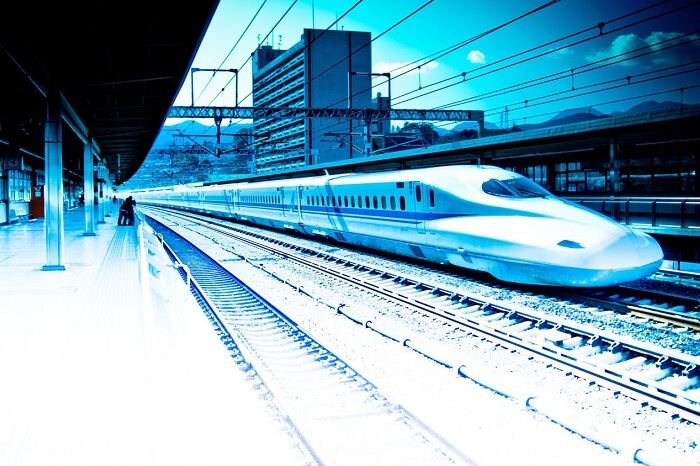 A bullet train whizzes pass a station