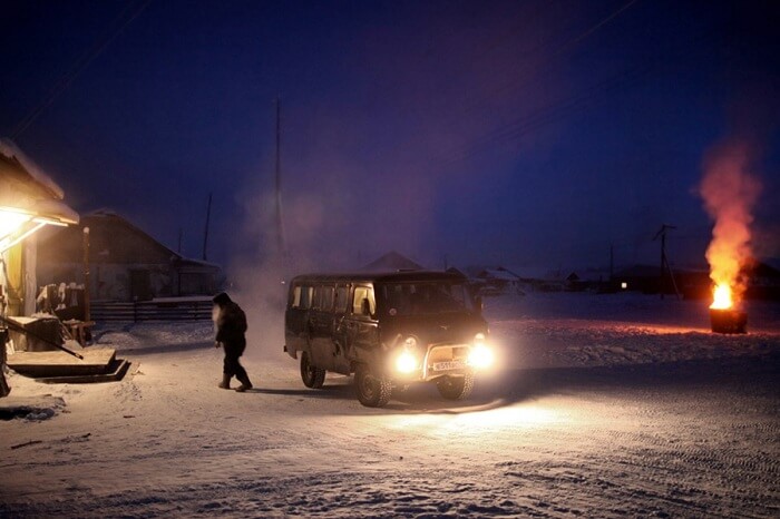 A local leaving the car engines running as he goes to purchase goods from the general store in Oymyakon during winters