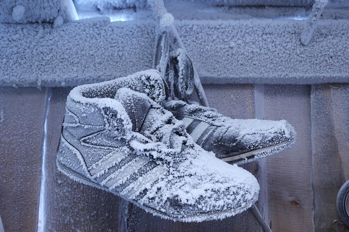 Snow-covered shoes hanging outside a house in Oymyakon in winters