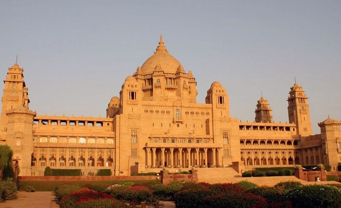The beautiful garden and the yellow sandstone monument of the Taj Umaid Bhawan Palace