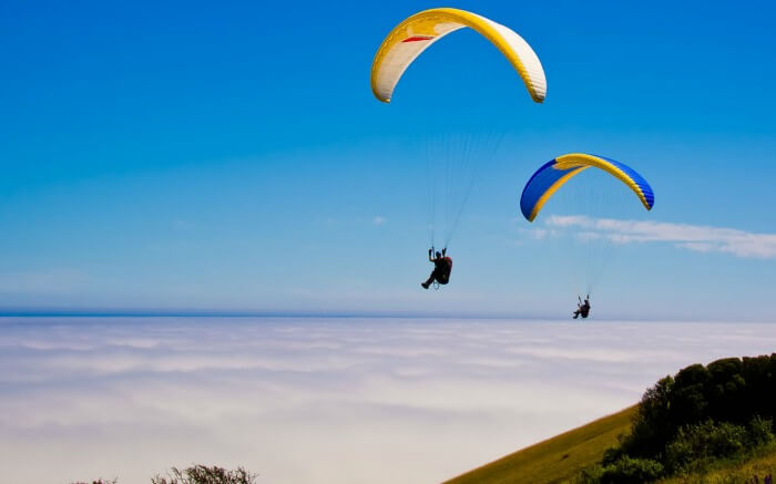 Tourists enjoying paragliding