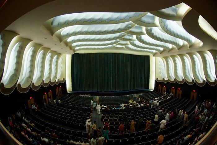 The opulent screening area of Raj Mandir cinema with velvet curtains on the screen