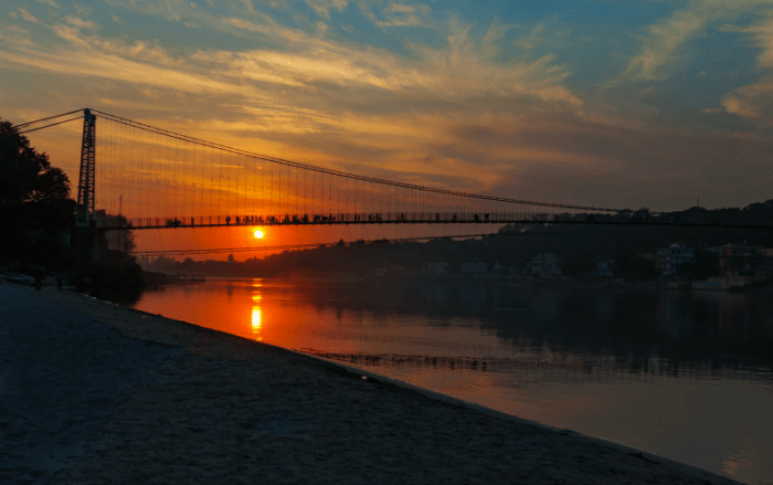 View of River Ganga and Ram Jhula bridge at sunset. Rishikesh. India
